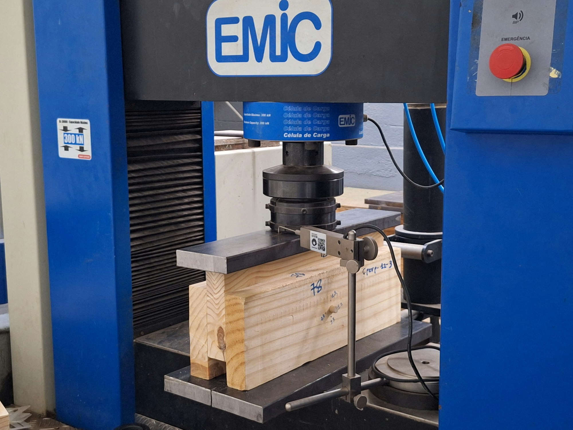 Materials testing frame loading a sample